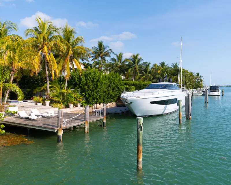 A boat moored at a dock in calm turquoise water