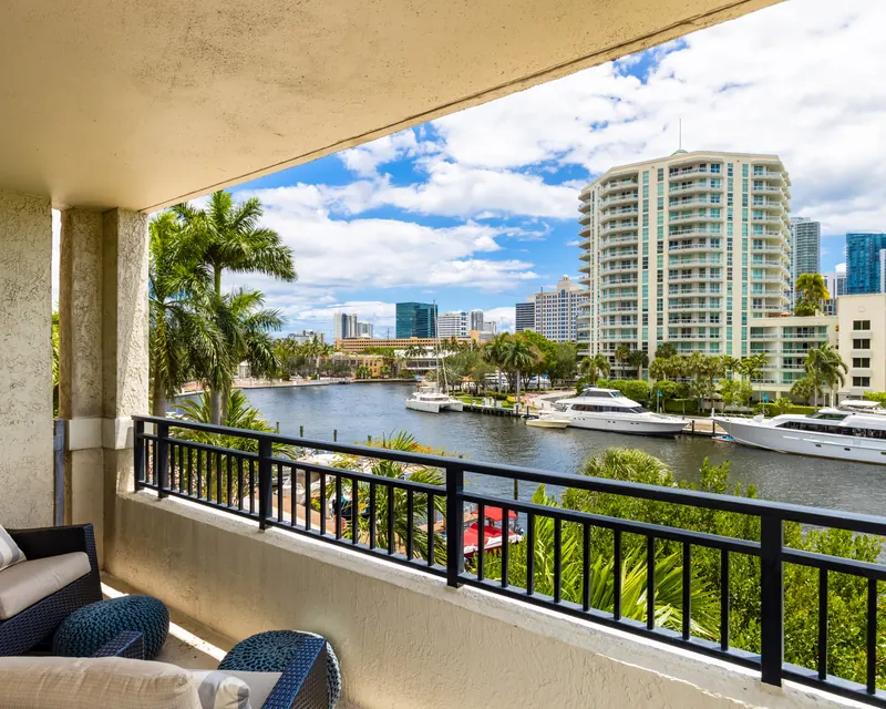 A condo balcony overlooking the water and city skyline