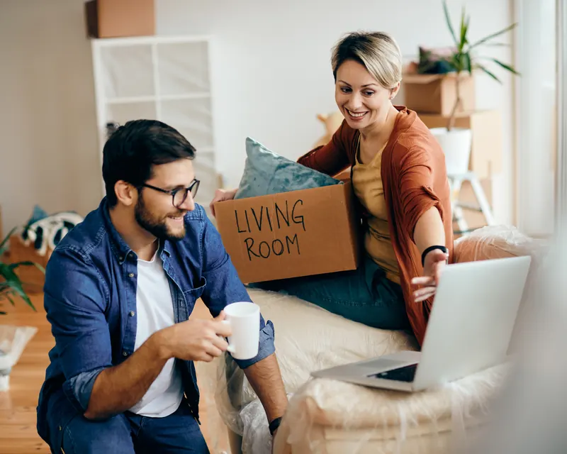 A couple unpacking moving boxes in their new rental home